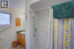 Bathroom featuring a shower stall and vanity - 