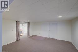 Finished basement with carpet floors and recessed lighting - 