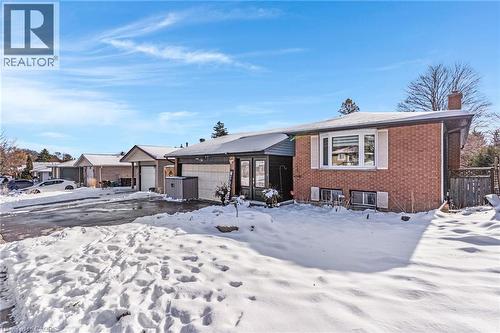 Raised Bungalow featuring brick siding, a chimney, and a garage - 136 Limpert Avenue, Cambridge, ON - Outdoor