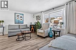 Living area with wood finished floors and a textured ceiling - 