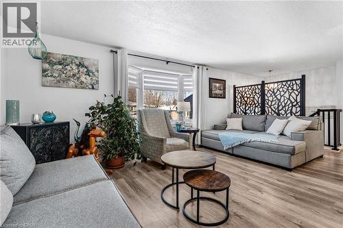 Living room with a textured ceiling and wood finished floors - 136 Limpert Avenue, Cambridge, ON - Indoor Photo Showing Living Room