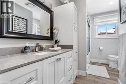 Bathroom with vanity, light wood-style floors, and bathing tub / shower combination - 