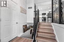 Stairs featuring wood finished floors and recessed lighting - 