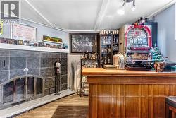 Indoor dry bar featuring a fireplace and wood counters - 