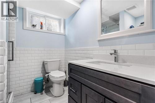 Full bathroom featuring a shower stall, vanity, a wainscoted wall, and tile walls - 136 Limpert Avenue, Cambridge, ON - Indoor Photo Showing Bathroom