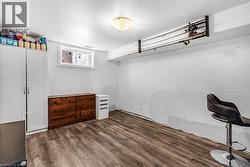 Walk in closet featuring dark wood-style floors - 