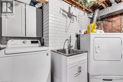 Washroom featuring cabinet space and washer and dryer - 