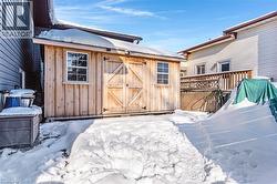 Snow covered structure with a storage unit - 