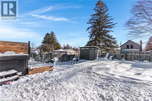 Snowy yard featuring a fenced backyard and a shed - 136 Limpert Avenue, Cambridge, ON - Outdoor