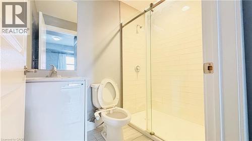 Bathroom with vanity, a shower stall, and tile patterned flooring - 155 St. Leger Unit# 107, Kitchener, ON - Indoor Photo Showing Bathroom