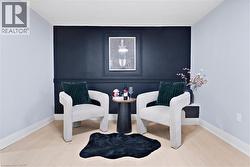 Sitting room with wood finished floors and an accent wall - 