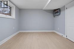 Below grade area featuring light wood-style flooring and baseboards - 