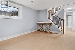 Staircase featuring wood finished floors and baseboards - 
