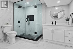 Bathroom featuring vanity, light marble finish flooring, recessed lighting, and a marble finish shower - 