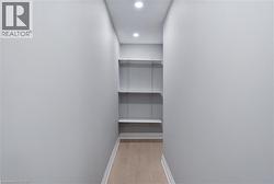 Walk in closet featuring light wood-style flooring - 