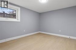 Empty room featuring light wood-style flooring and baseboards - 