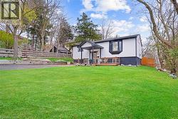View of front of property with a deck and brick siding - 