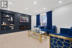 Living room featuring wood finished floors, recessed lighting, and a large fireplace - 