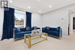 Living area with recessed lighting and wood finished floors - 