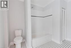 Full bath featuring a closet, shower / tub combination, and ornamental molding - 