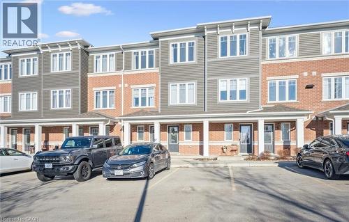 View of property featuring uncovered parking and a residential view - 24 Morrison Road Unit# D9, Kitchener, ON -  Photo Showing Garage