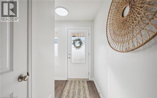 Doorway featuring baseboards and wood finished floors - 24 Morrison Road Unit# D9, Kitchener, ON - Indoor Photo Showing Other Room