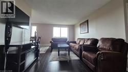Living area featuring baseboard heating and dark type flooring - 