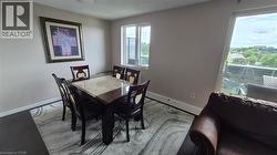 Dining space with a baseboard heating unit and wood finished floors - 