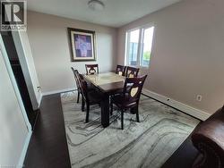 Dining area with baseboard heating and wood finished floors - 