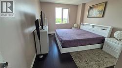 Bedroom featuring finished floors and baseboards - 