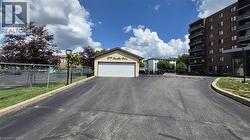 View of building exterior featuring street lights and curbs - 