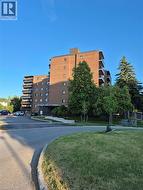 View of apartment building / complex with uncovered parking - 