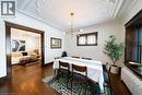Dining area featuring a chandelier, dark wood-style floors, ornamental molding, and radiator - 184 Weber Street E, Kitchener, ON  - Indoor 