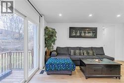 Living room with light wood-style floors and recessed lighting - 