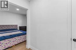 Bedroom with light wood-type flooring and recessed lighting - 