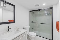Bathroom featuring vanity, recessed lighting, and a marble finish shower - 
