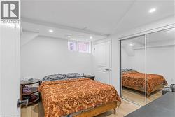 Bedroom featuring vaulted ceiling, light wood-style floors, recessed lighting, and a closet - 