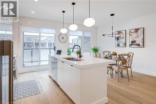 Kitchen featuring dishwasher, modern cabinets, a sink, white cabinetry, and light wood finished floors - 151C Port Robinson Road, Pelham, ON - Indoor Photo Showing Kitchen With Double Sink With Upgraded Kitchen