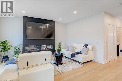 Living room with baseboards, recessed lighting, and wood finished floors - 151C Port Robinson Road, Pelham, ON - Indoor With Fireplace