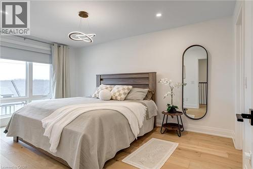 Bedroom featuring baseboards, recessed lighting, a notable chandelier, and light wood-style floors - 151C Port Robinson Road, Pelham, ON - Indoor Photo Showing Bedroom