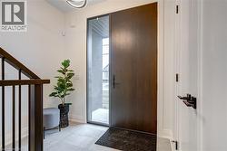 Entrance foyer with light tile patterned floors and baseboards - 