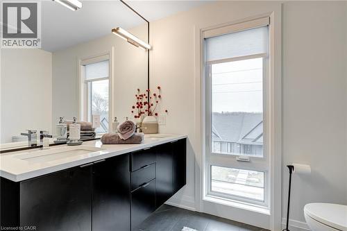 Bathroom featuring vanity, baseboards, tile patterned flooring, toilet, and visible vents - 151C Port Robinson Road, Pelham, ON - Indoor Photo Showing Bathroom