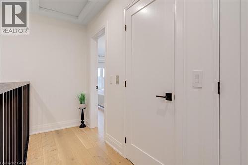 Corridor featuring light wood-style flooring, attic access, and baseboards - 151C Port Robinson Road, Pelham, ON - Indoor Photo Showing Other Room