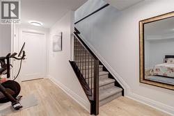 Stairs with baseboards and wood finished floors - 