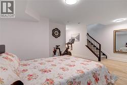 Bedroom featuring baseboards and wood finished floors - 