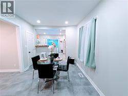 Dining room with recessed lighting and vinyl floors - 