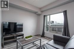 Living area with light wood-type flooring - 