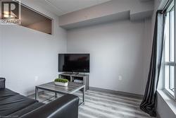 Living room featuring healthy amount of natural light and light wood-style flooring - 