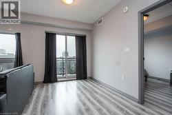 Spare room with light wood-style flooring, healthy amount of natural light, and a smoke detector - 