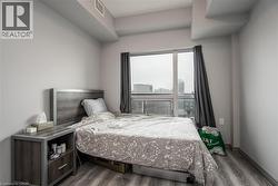 Bedroom featuring dark wood-type flooring and baseboards - 